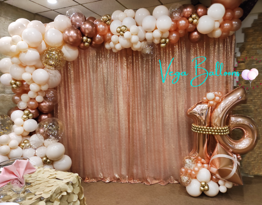 round backdrop with half arch rose gold balloons