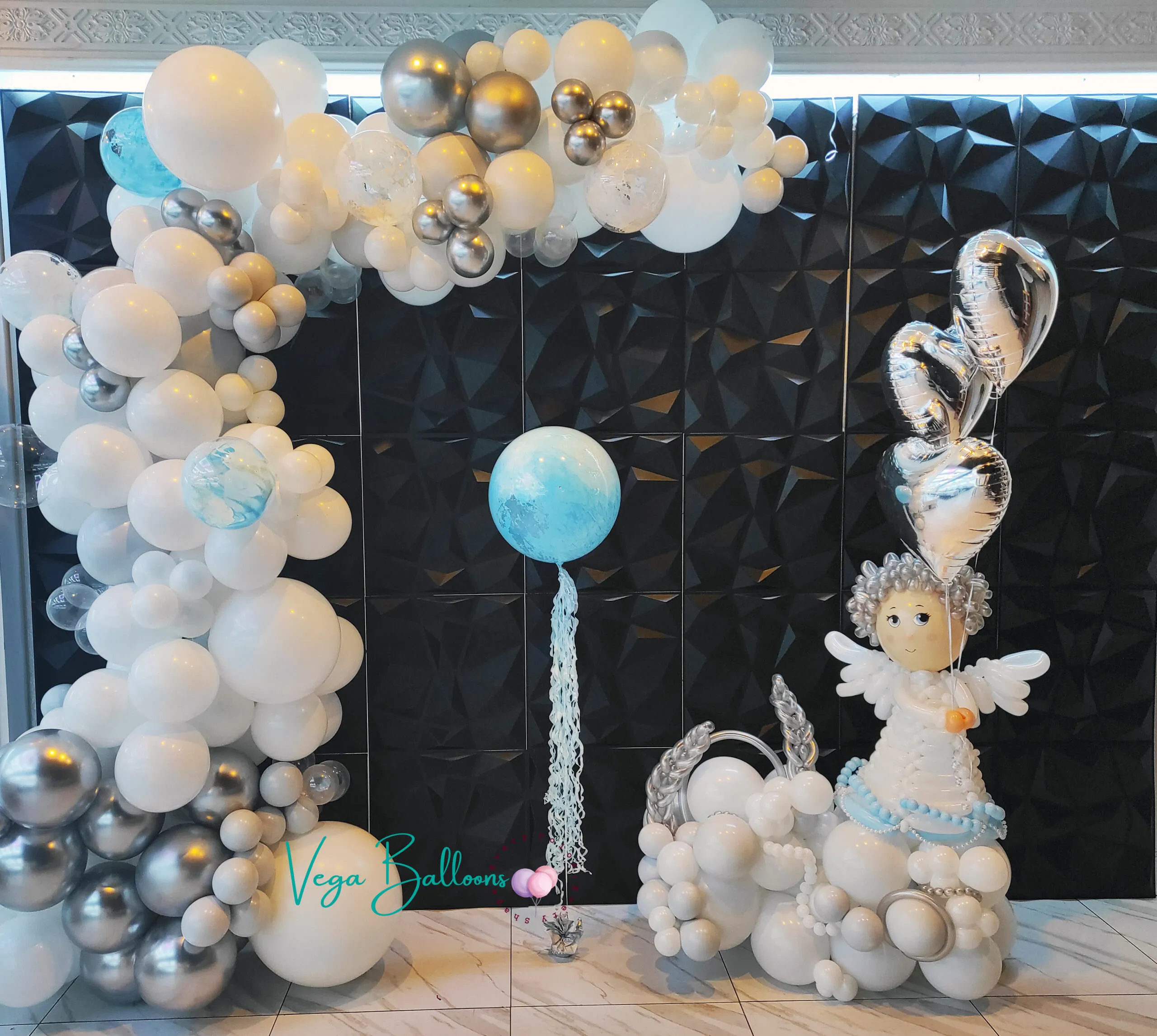 organic arch for baby shower with crafted balloon angel sculpture