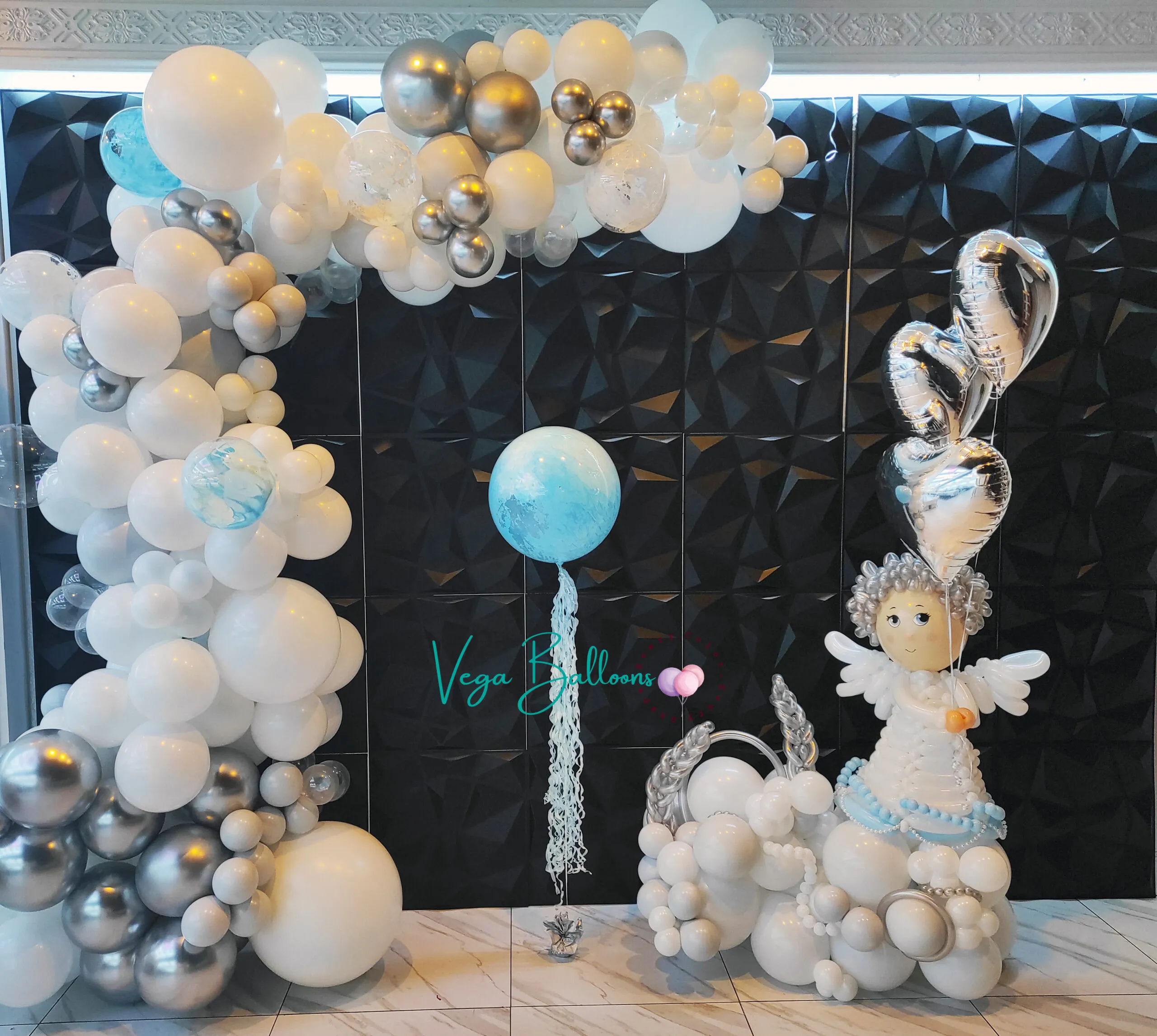 organic arch for baby shower with crafted balloon angel sculpture