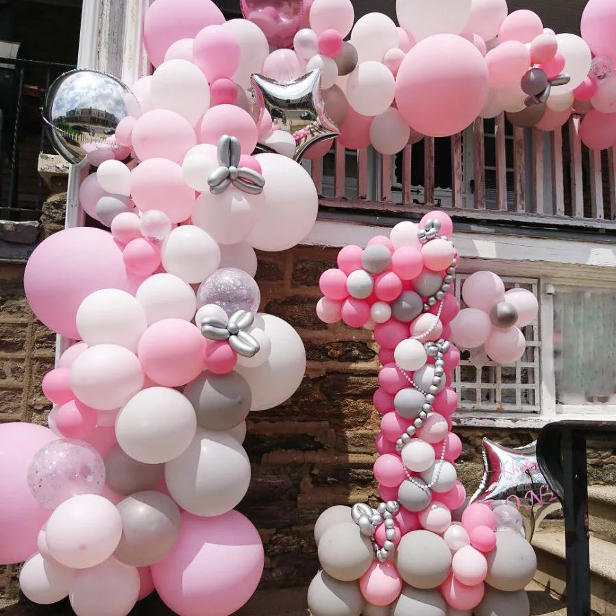 pink organic arch with crafted number one centerpiece